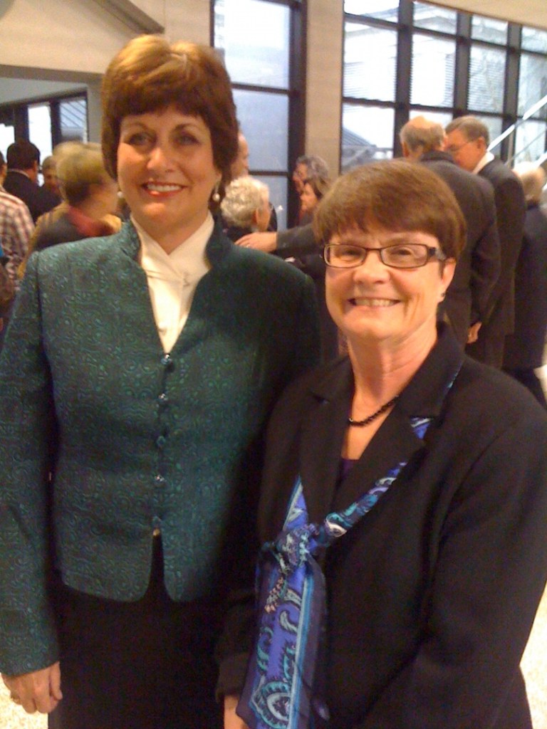 Two in photo, big windows in background