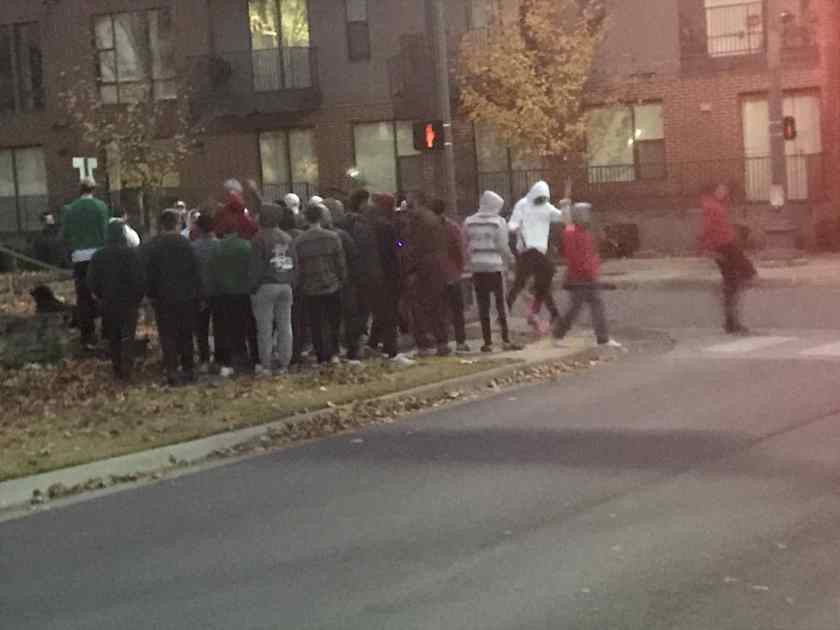 Non-masked, non-socially distanced brothers of a University of Arkansas fraternity stand outside a Maple Street sorority across from The Academy at Frisco apartments, Fayetteville, 6 a.m. Nov. 13, 2020.
