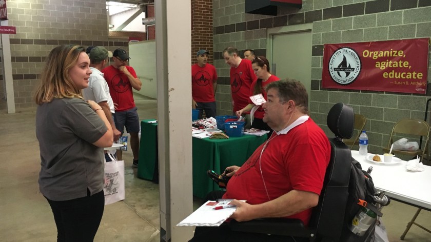 965 Treasurer Hershel Hartford talks with a U of A staff member May 19 at the 2022 Staff Appreciation Picnic at Reynolds Razorback Stadium.