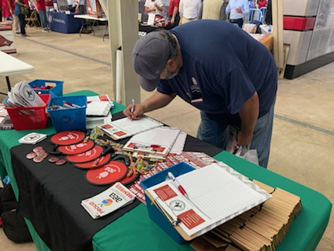 A U of A staff member signs up for the Local 965 mailing list May 19 at the 2022 Staff Appreciation Picnic at Reynolds Razorback Stadium.