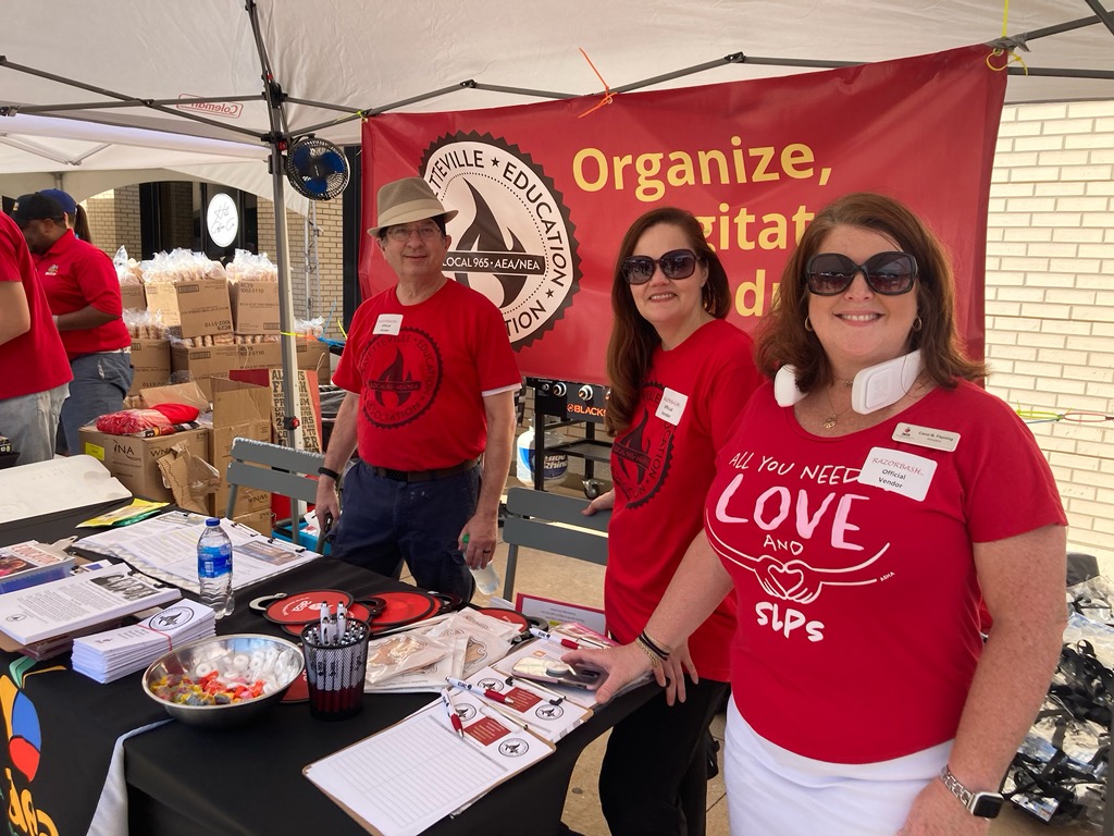 Local 965 Secretary Ben Pollock, UniServ Director Renee Johnson of the Arkansas Education Association and AEA President Carol B. Fleming are ready Aug. 24 to greet the first employees and students at the 2022 Razorbash on the Fayetteville campus.