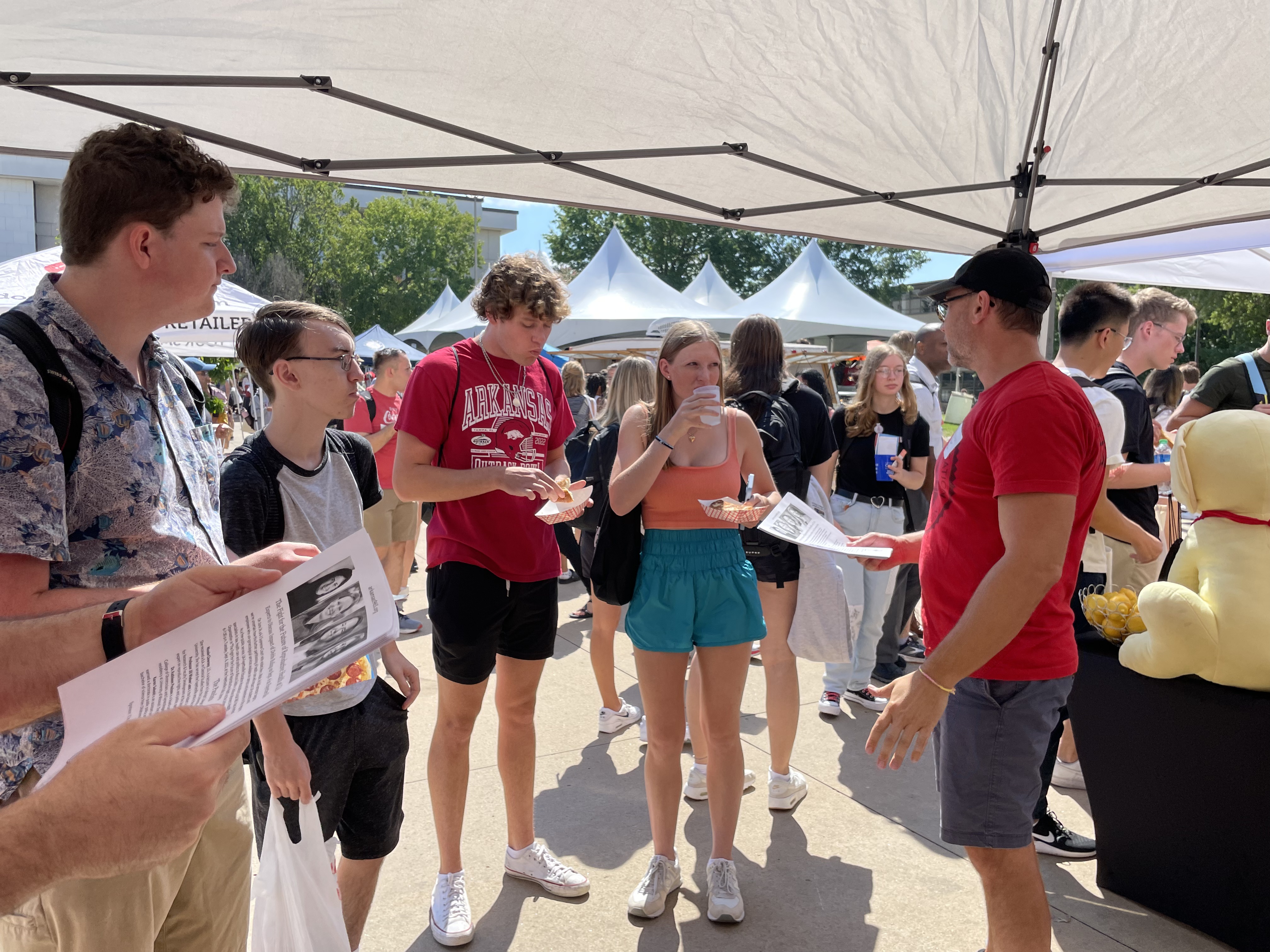 Local 965 President Bret Schulte explains the union's Sept. 6 public discussion "The Fight for the Future of Reproductive Health at the University of Arkansas" to undergraduates Aug. 24 at the 2022 Razorbash community fair on the Fayetteville campus.