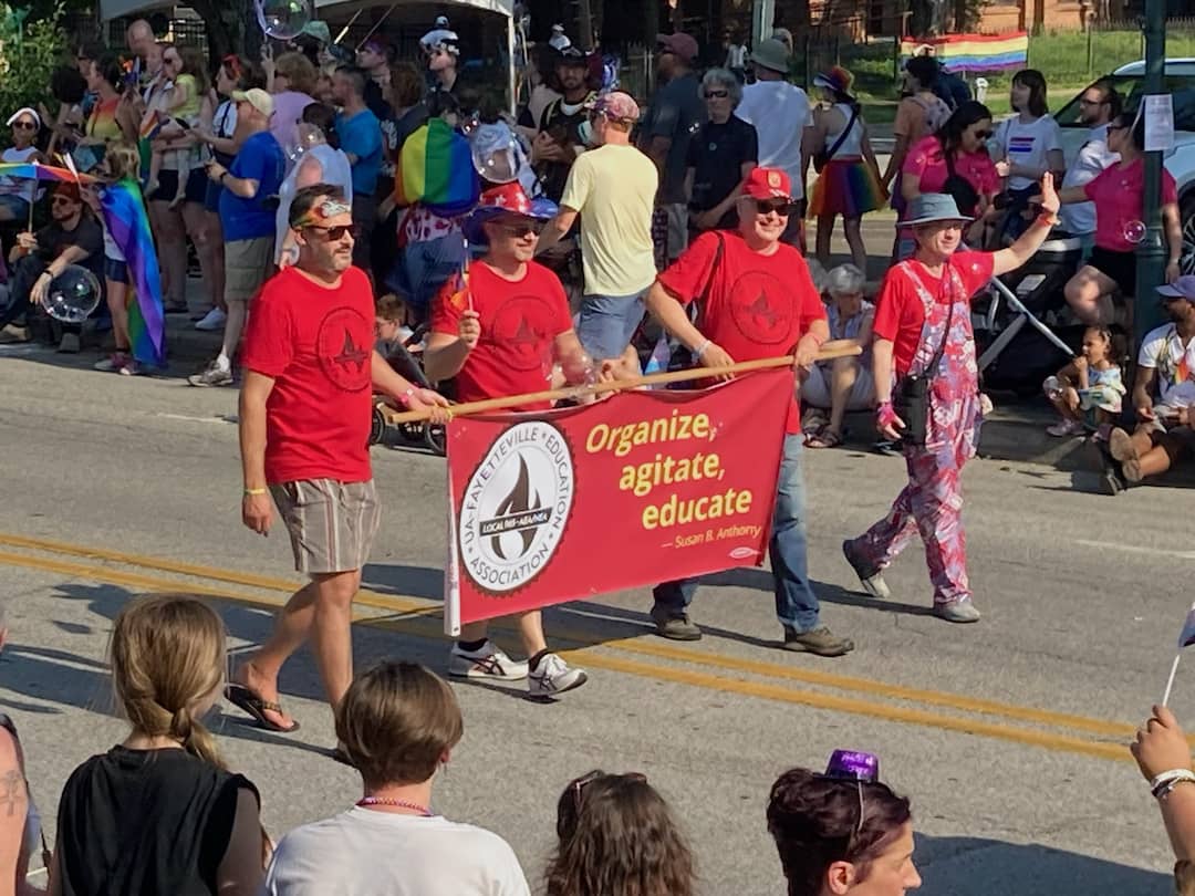 University of Arkansas workers Matt Stanley, Bret Schulte, Ted Swedenburg and Ben Pollock are in full parade mode for their Local 965 in the 19th annual NWA Pride Parade on June 24, 2023.