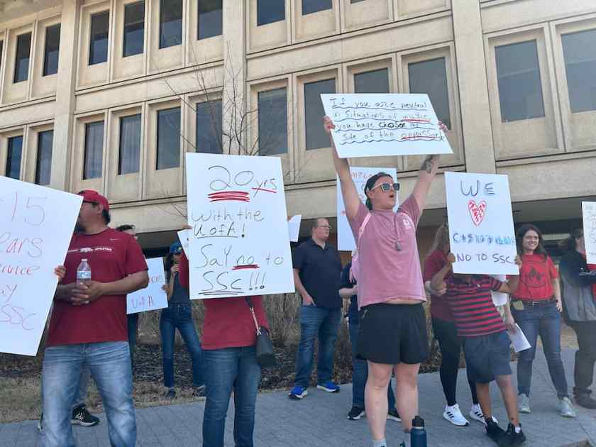 A dozen protesters conclude the march outside the Administration Building.
