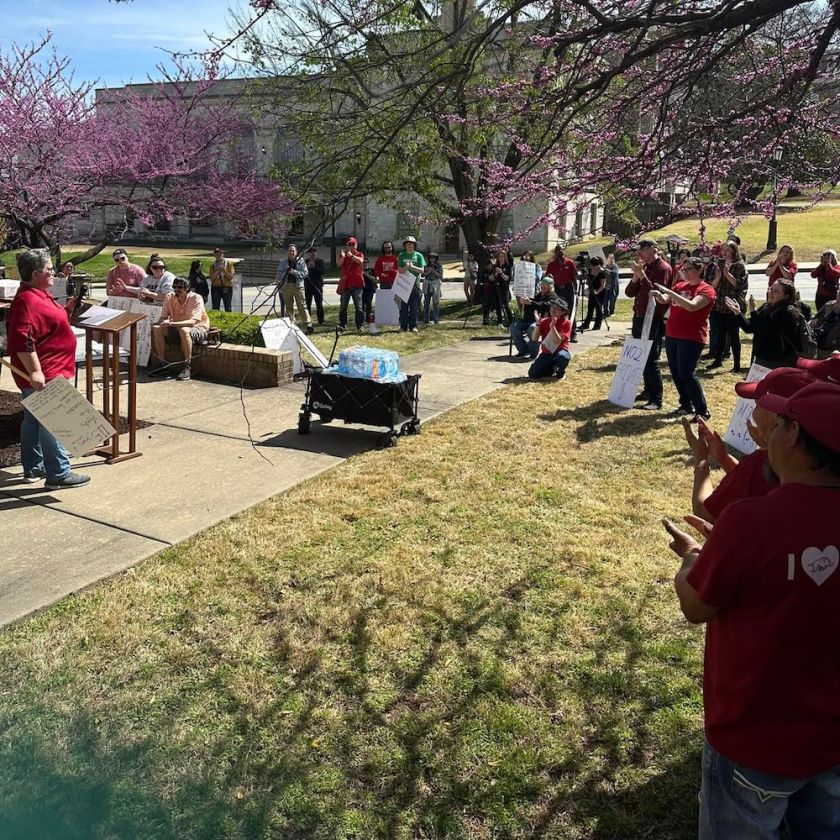 A custodial supervisor tells marchers about her concerns about proposed outsourcing.
