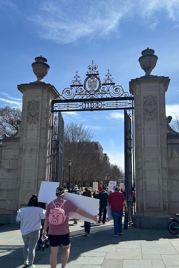 Protesters pass through UA's Pi Beta Phi Centennial Gate to enter the Fayetteville campus.