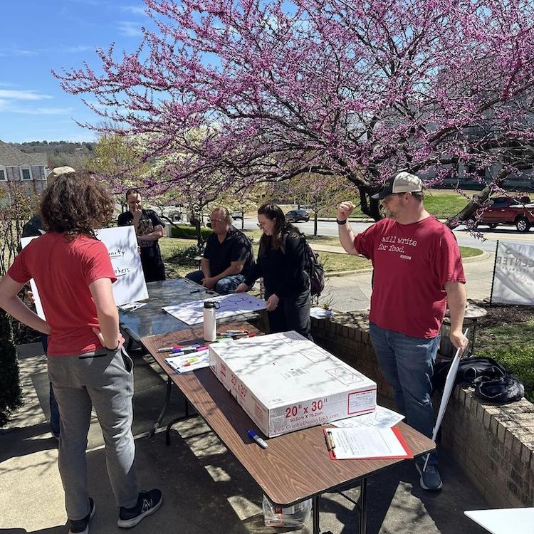 Marchers prepare their pickets at the sign-painting tables.