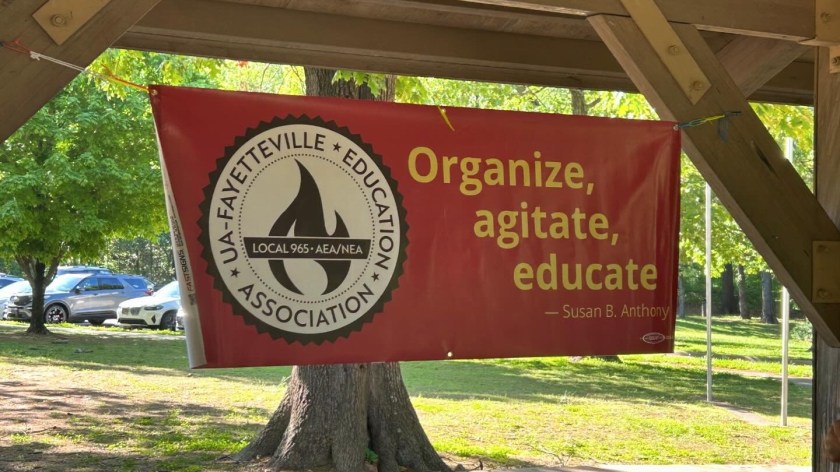 The banner of Local 965 is mounted above the food table at its 2024 Workers Day Cookout in Fayetteville's Veterans Memorial Park.