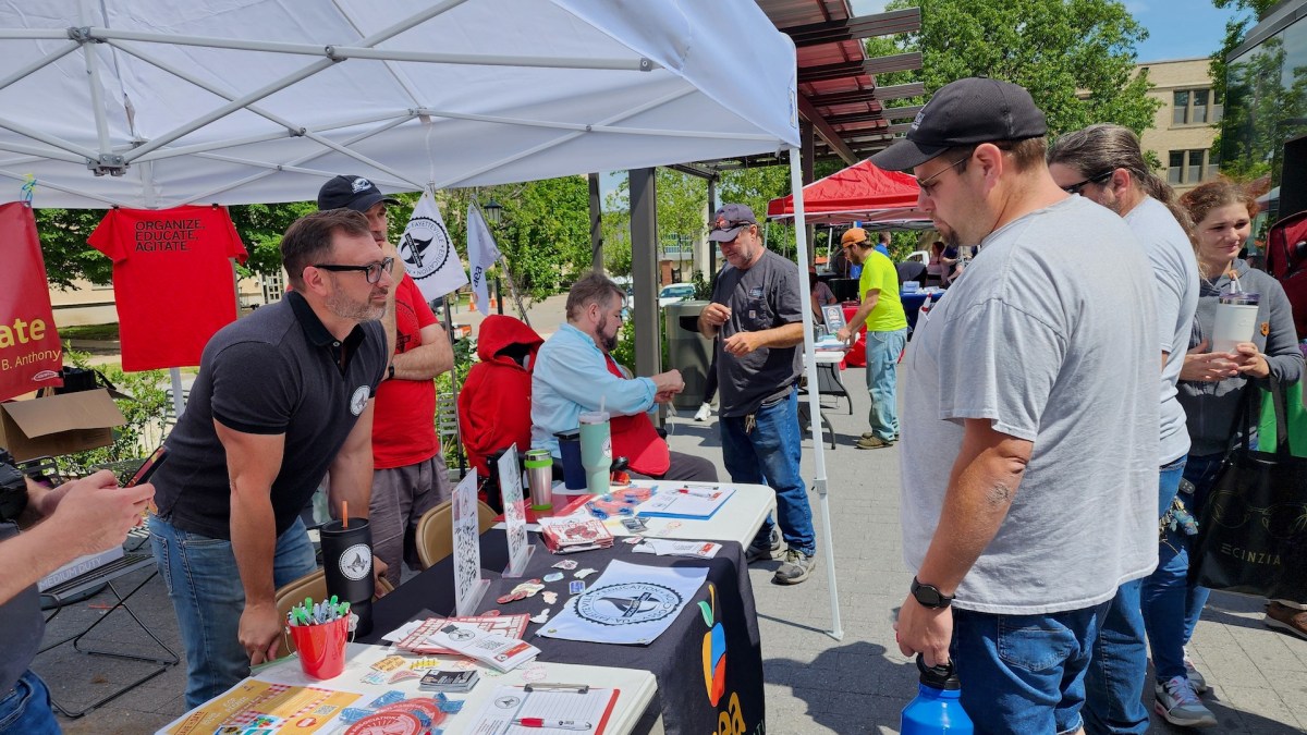 Local 965 board members Bret Schulte and Michael Pierce and President Hershel Hartford talk with UA employees.