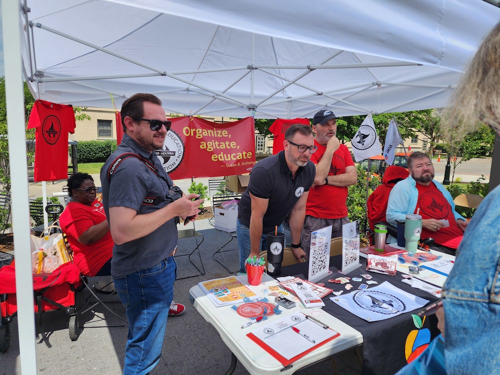 Local 965 board members Bret Schulte and Michael Pierce and President Hershel Hartford take a question from a UA staffer.