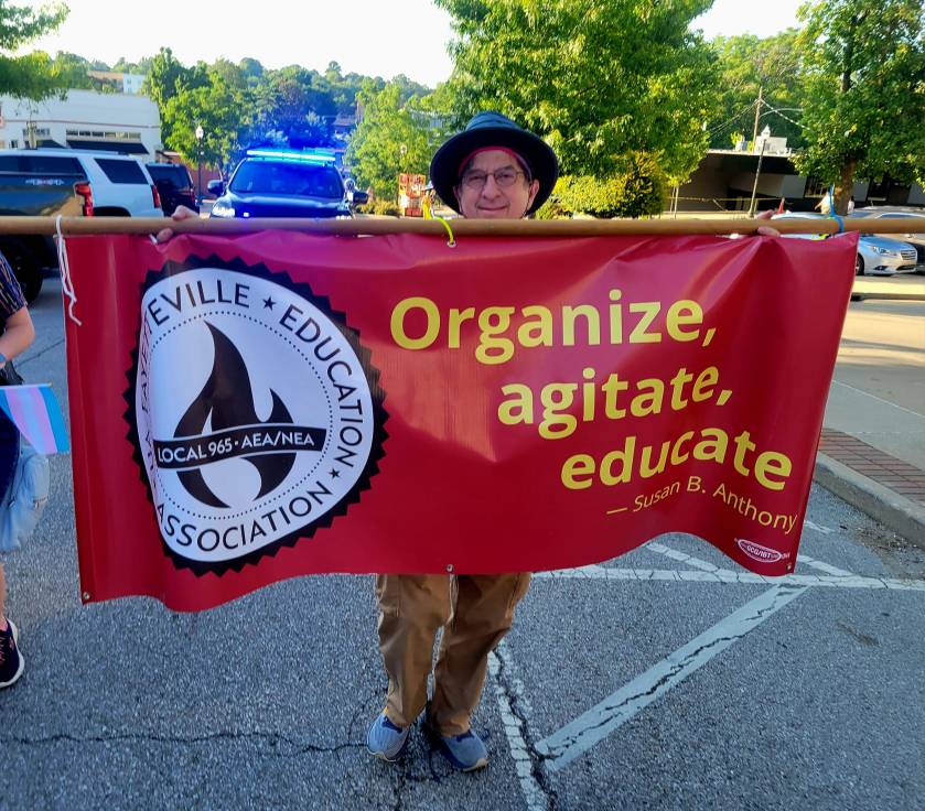 Local 965 Vice President Ben Pollock courses down Block Avenue June 28, 2024, in the NWA Trans March.