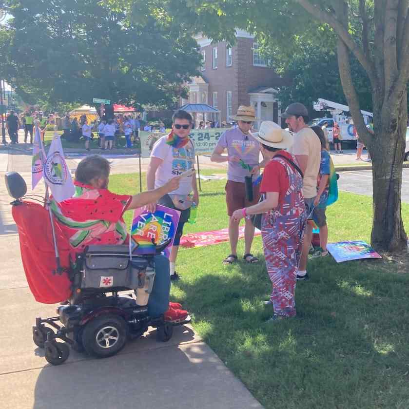 Local 965 President Hershal Hartford hands out flyers to UA employees June 29 while waiting for the 2024 Pride Parade to start.