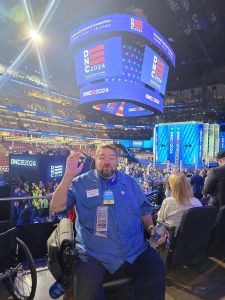 Local 965 President Hershel Hartford awaits the first night of speeches at the 2024 Democratic National Convention in Chicago, sitting with the Democratic Party of Arkansas delegation.