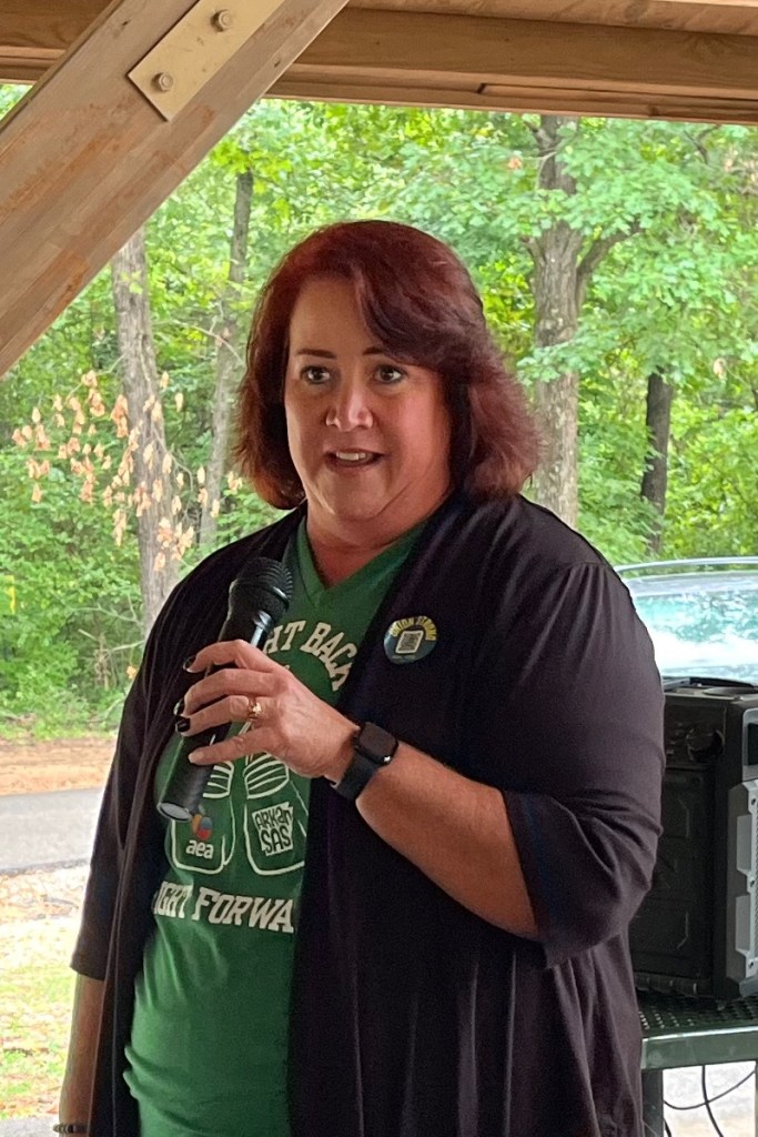 President April Reisma of the Arkansas Education Association speaks Sept. 1, 2025, at Labor's Labor Day picnic at Fayetteville's Veterans Memorial Park.