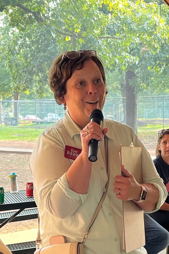 Lisa Parks, a candidate for prosecuting attorney of the 4th Judicial District of Arkansas (Washington and Madison counties) speaks Sept. 1, 2025, at Labor's Labor Day picnic at Fayetteville's Veterans Memorial Park.