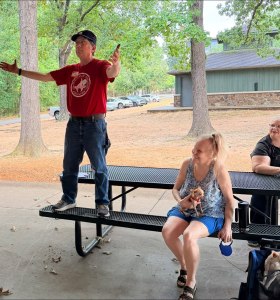 Ben Pollock, president of UA-Fayetteville Educational Association, hails the estimated 6 dozen attending the 2026 Labor Day Labor Picnic, Sept. 7, at Veterans Memorial Park in Fayetteville.